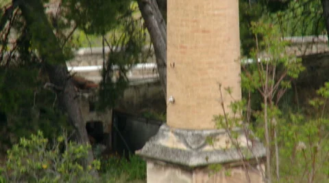 Tilt on red brick chimney with trees in background 스톡 동영상 47977920