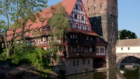 Tilt up from reflection of Wasserturm in the River Pegnitz in Nuremberg Stock Footage 260817788