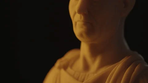 Tilt up reveal of Caesar face marble bust statue Stock Footage 144393028
