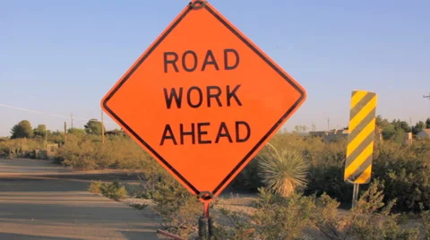 Tilt to Reveal a Road Work Ahead Sign Stock Footage 64330704