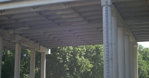 Tilt of river underneath overpass Stock Footage 89777070