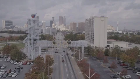 Tilt up from Road Fly Over Olympic Rings to Atlanta Skyline Stock Footage 82440189