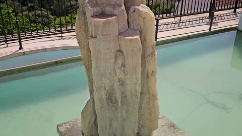 Tilt up-Rough stone pillar tilts up to view lush green Corfu, Greek valley Stock Footage 296355266