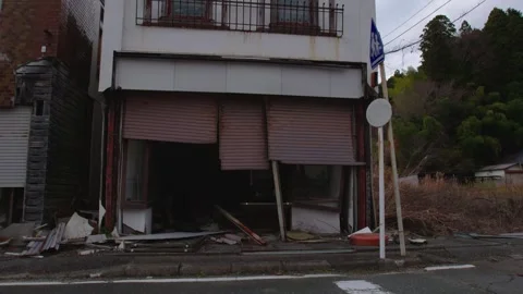 Tilt-Up of Ruined Building with Broken Shutters and Debris in Japan Stock Footage 336565982