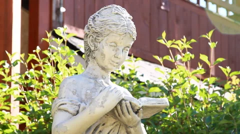 Tilt Up on Sculpture of Reading Child Stock-Footage 44346954