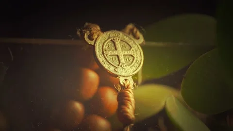 Tilt selective focus shot of a Saint Benedict rosary in the dark Stock-Footage 163921006
