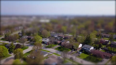 Tilt shift aerial over the suburbs on a sunny, spring day. Stock Footage 131006091