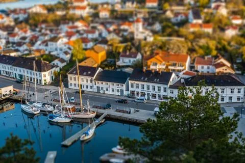 Tilt shift. Aerial view to Risor city in Norway. Motorboat entering the har.. Stock Photos