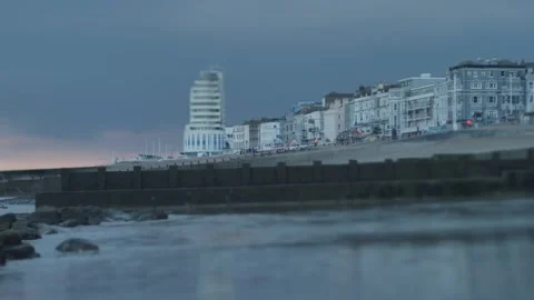Tilt shift beach front properties in Hastings around sunset slow motion 4K Video stock 285404400