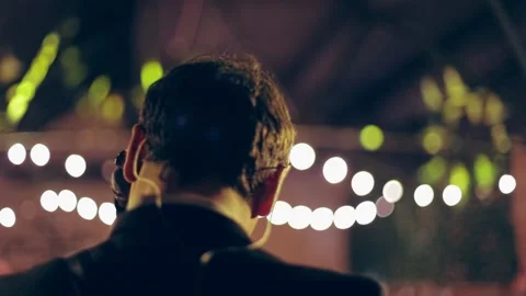 Tilt-shift dreamy effect vocalist with guitar and in-ear headphones on the Stock Footage 150152500