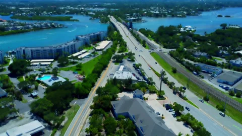 Tilt-shift Drone view of traffic going over the bridge in Jupiter Florida Stock Footage 346642954