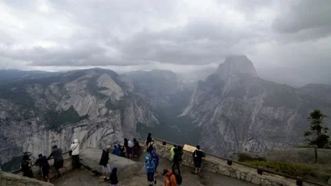 Tilt-shift effect at Glacier Point overlook in Yosemite, tourists taking photos Stock Footage 134577431