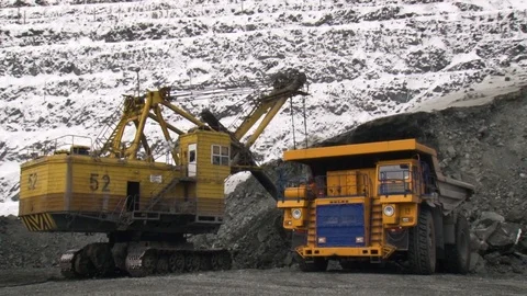 Tilt shift perspective of trucks excavating in quarry. Mining operations. Stock Footage 119155403