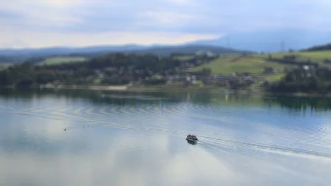 Tilt shift ship sails on the middle of lake Stock Footage 95248082