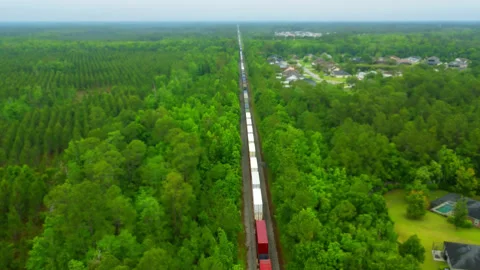 Tilt-shift Static drone shot of a train going through the woods in upper Flo Stock Footage 346643358