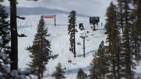 Tilt Shift Timelapse of Skiers and Snowboarders unloading chairlift Stock Footage 24759586