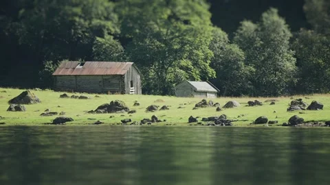 Tilt-shift video of two old wooden barns on the rocky coast of a fjord, Stock Footage 280477008