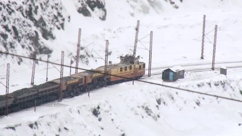 Tilt shift view of the train carrying coil at winter near the career Stock Footage 119155341