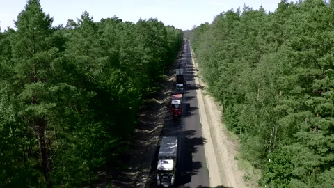 Tilt-Up Shot Above A Two-Lane Road In The Middle Of The Green Fields Stock Footage 142000637