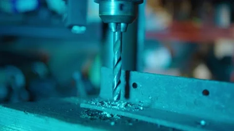 Tilt shot of bench drill drilling into a piece of metal Stock Footage 175179176