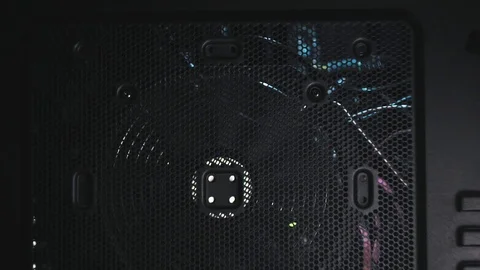 Tilt shot on black tower side with big spinning fan. Flicker blue light insde Видео 101372437