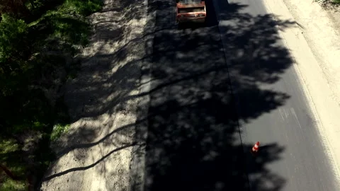 Tilt-Up Shot Of Construction Worker And Road Rollers In A Forest Stock Footage 142000246