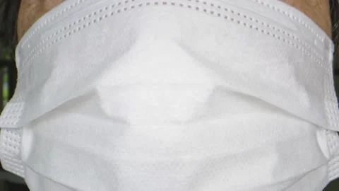 Tilt up shot of elderly woman's face while wearing a protective face mask Stock Footage 130544039