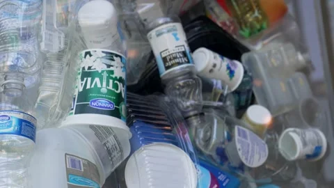 Tilt shot of empty plastic trash containers Video stock 152349593