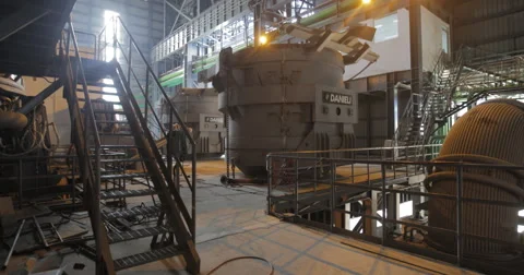 Tilt Up Shot Of Factory Workers Walking Near a Blast Furnace (4K) Stock Footage 60767222