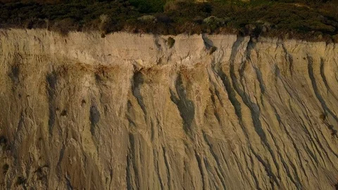 Tilt shot gliding from steep cliffs to crushing waves on sand banks, Point Reyes Stock Footage 94876242