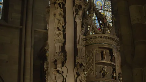 Tilt shot of gothic cathedral interior with stained glass windows, statues Stock Footage 315400258