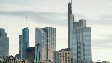Tilt shot to Holbeinsteg bridge from the Frankfurt Skylin Stock Footage