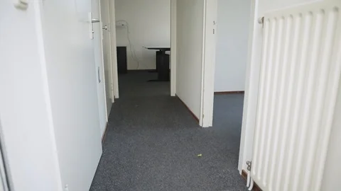 Tilt Shot Inside The Hallway Of An Office With White Walls And A Black Floor Stock Footage 126700617
