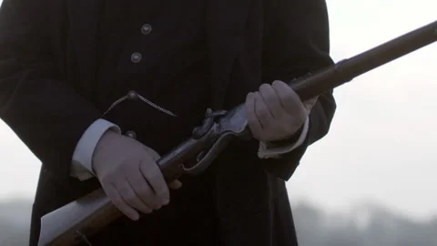 Tilt-up shot of Lincoln preparing to shoot a gun, 1863s, USA - Reenactment Stock Footage 241996308