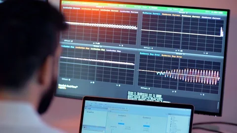 Tilt Shot Of A Man Looking At Graphs On His Computer Stock Footage 129398979