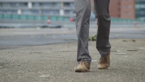 Tilt Shot Off A Man Passing By The Camera On A Highway With Driving Cars Stock Footage 126701167