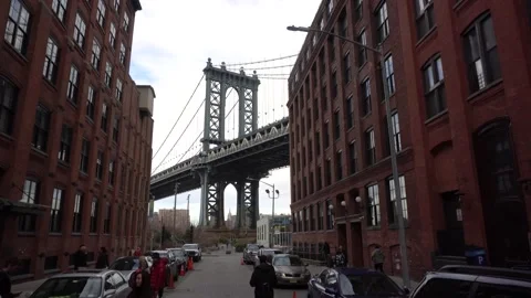 Tilt shot of the Manhattan Bridge between buildings, NYC Stock Footage 166753254
