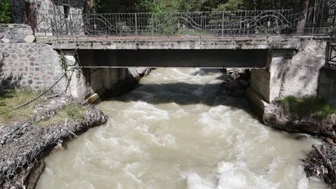 Tilt up shot of mountain river and stone bridge Stock Footage 337048646