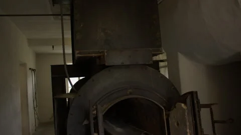 Tilt shot of an old crematorium with an open metal chamber. Stock Footage 299050198