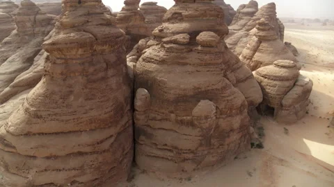 Tilt Up Shot Of Rock Formed Structures In Desert Against Sky - AlUla, Saudi Stock Footage 163812696