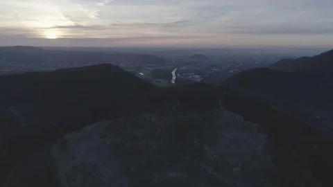 Tilt-up shot of a rock mining complex revealing a river into the city Graz, 4K Stock Footage 73781677