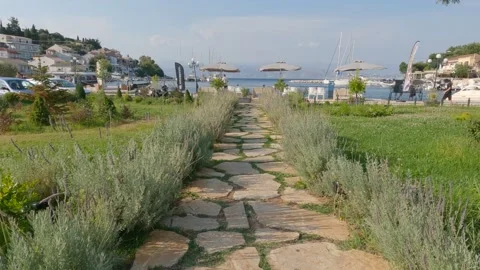 Tilt Up Shot From Rustic Garden Path Leading To promenade With Parasols In 動画素材 221217763
