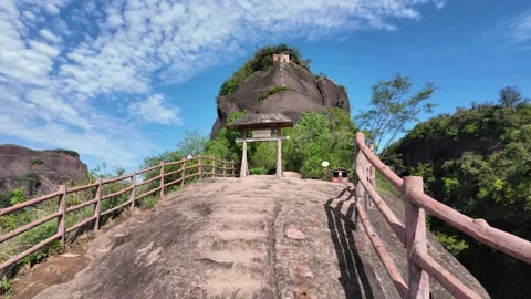 Tilt up shot of a stone pathway leading through a traditional wooden gateway Stock Footage 339638247