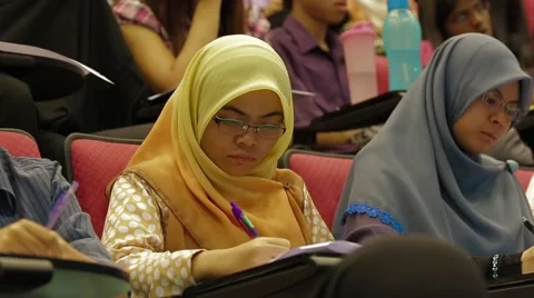 Tilt Up Shot From Students Taking Notes to Students Listening to Lecture Stock Footage 49387492
