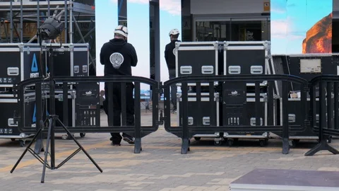 Tilt up shot of the technical preparation of the stage of an outdoor event Stock Footage 123404261