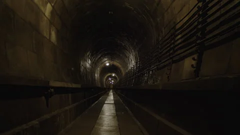 Tilt shot of an underground tunnel with segmented concrete ceiling Stock Footage 301033735