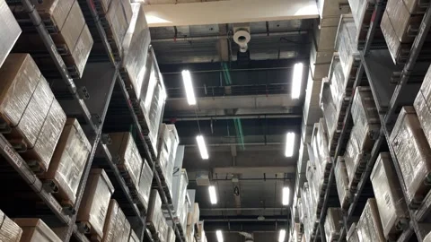 Tilt Up Shot of Warehouse Rows with Stacked Shipping Boxes Stock Footage 333472360