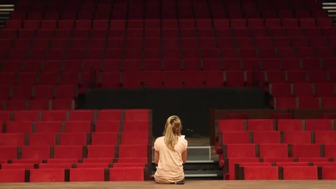 Tilt Shot Of Woman Reading A Script All By Herself In A Theatre Vídeo Stock 126701078