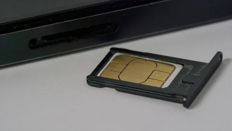 Tilt up to sim card in cradle with smart phone Stock Footage