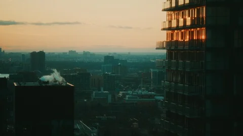 Tilt up to Skyscraper Sunset reflected in glass of condo building. Stock Footage 101666754